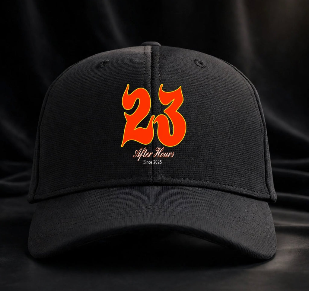 A black baseball cap featuring a prominent orange and red flame-style '23' graphic on the front, with 'After Hours Since 2025' written in white script underneath, set against a dark draped background.