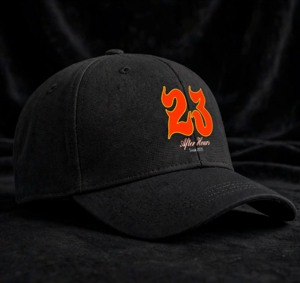 A black baseball cap with a curved brim, featuring a prominent orange and yellow flame-style '23' logo on the front, with 'After Hours' and 'Est. 2025' below it.