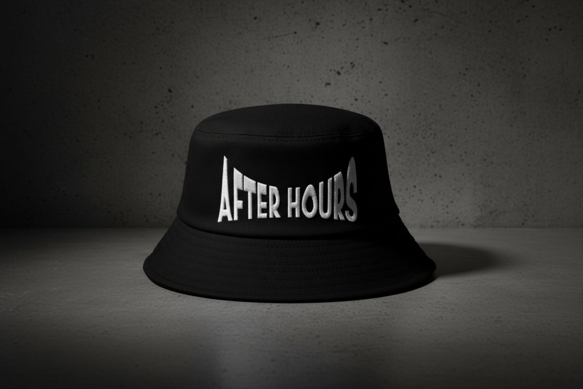 Black bucket hat with 'AFTER HOURS' text embroidered on a grey background