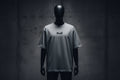 Grey t-shirt with a small black logo embroidered on a grey background