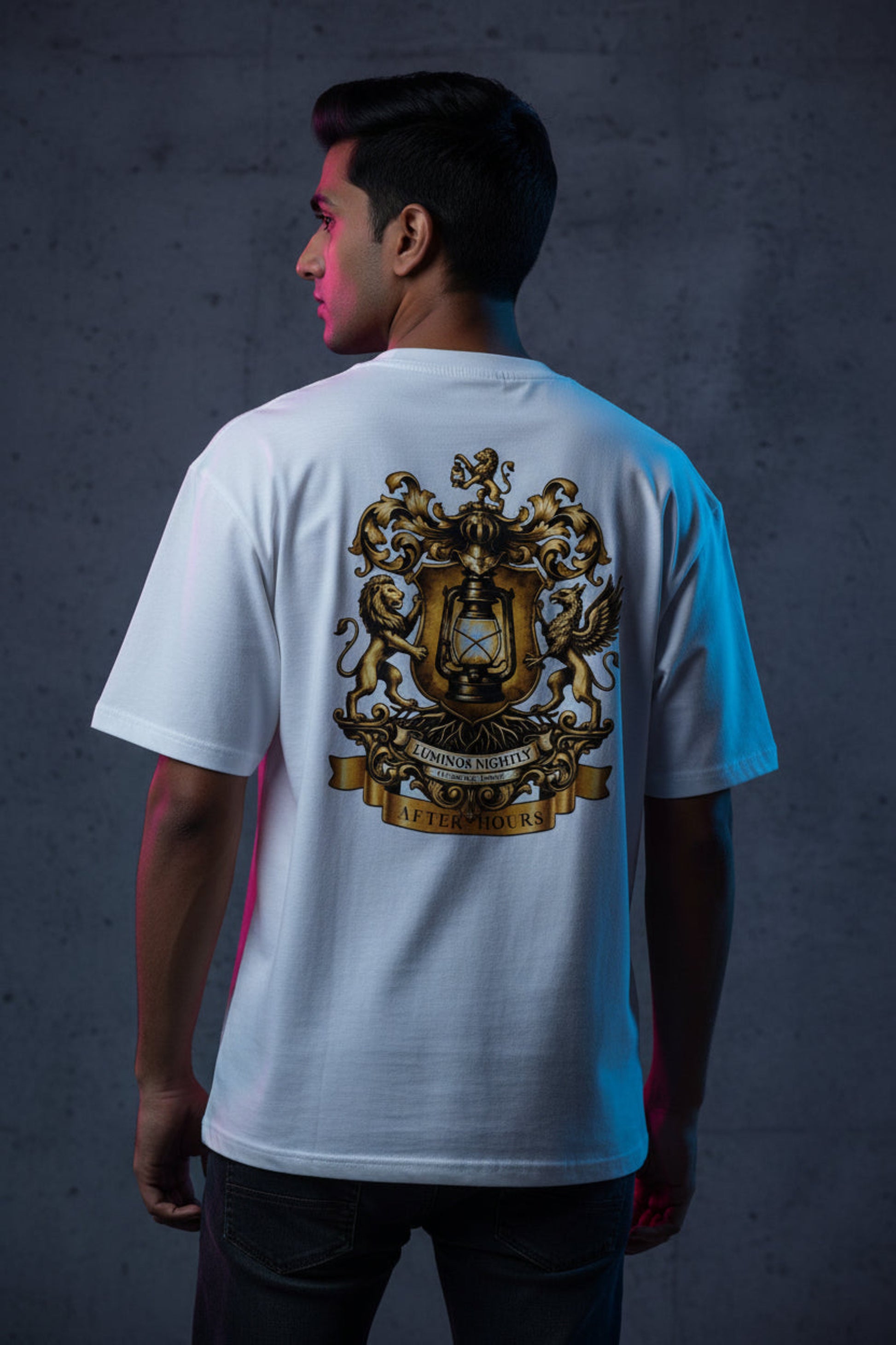 White t-shirt with a gold After Hours Coat of Arms design on a grey background