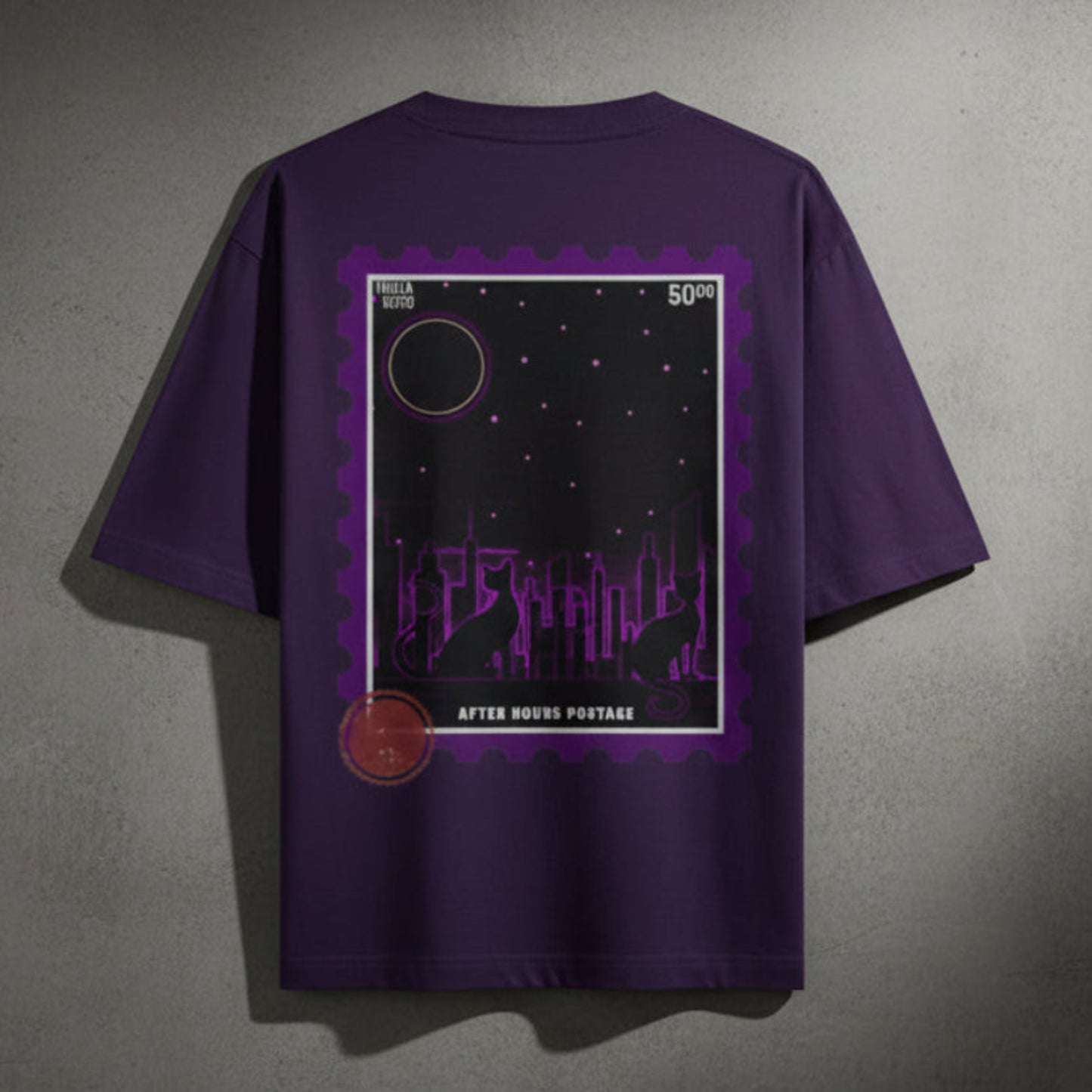 Purple t-shirt with a graphic design on the back against a grey textured wall background