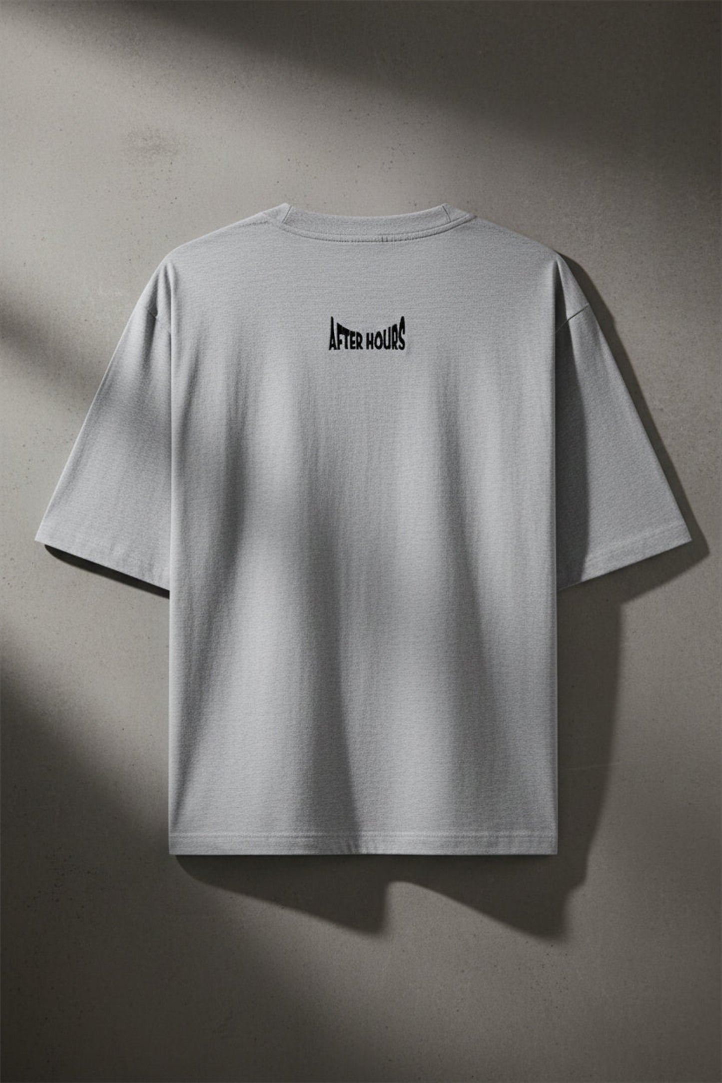 Grey t-shirt with 'After Hours' text embroidered on the back against a grey background