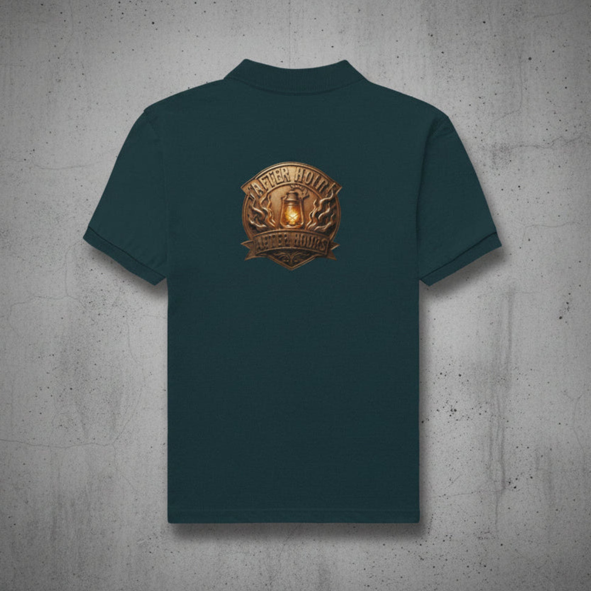 Petrol blue t-shirt with a gold and brown logo on the back against a grey textured wall background