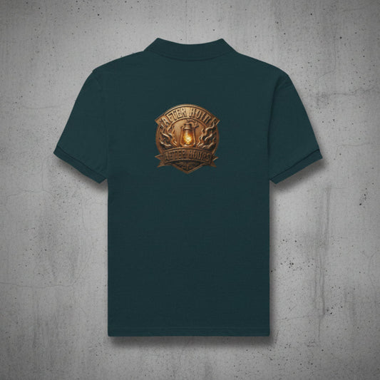 Petrol blue t-shirt with a gold and brown logo on the back against a grey textured wall background