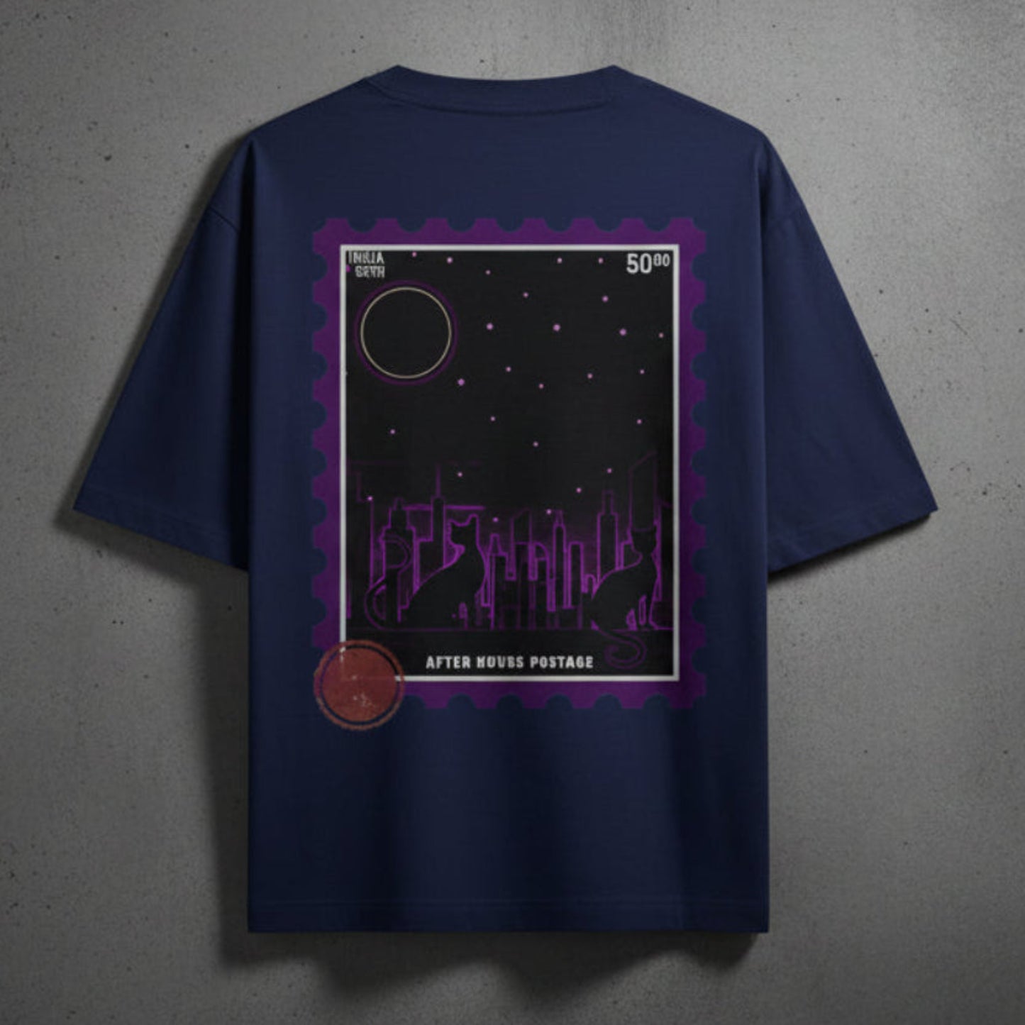 Royal blue t-shirt with a purple graphic design on the back against a grey textured wall background