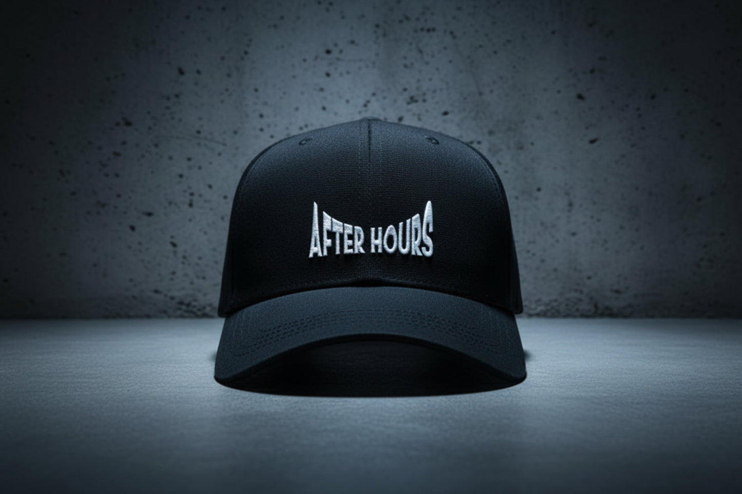 Black cap with 'After Hours' text embroidered on a grey background