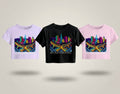 Three t-shirts with colourful cityscape designs on a light grey background