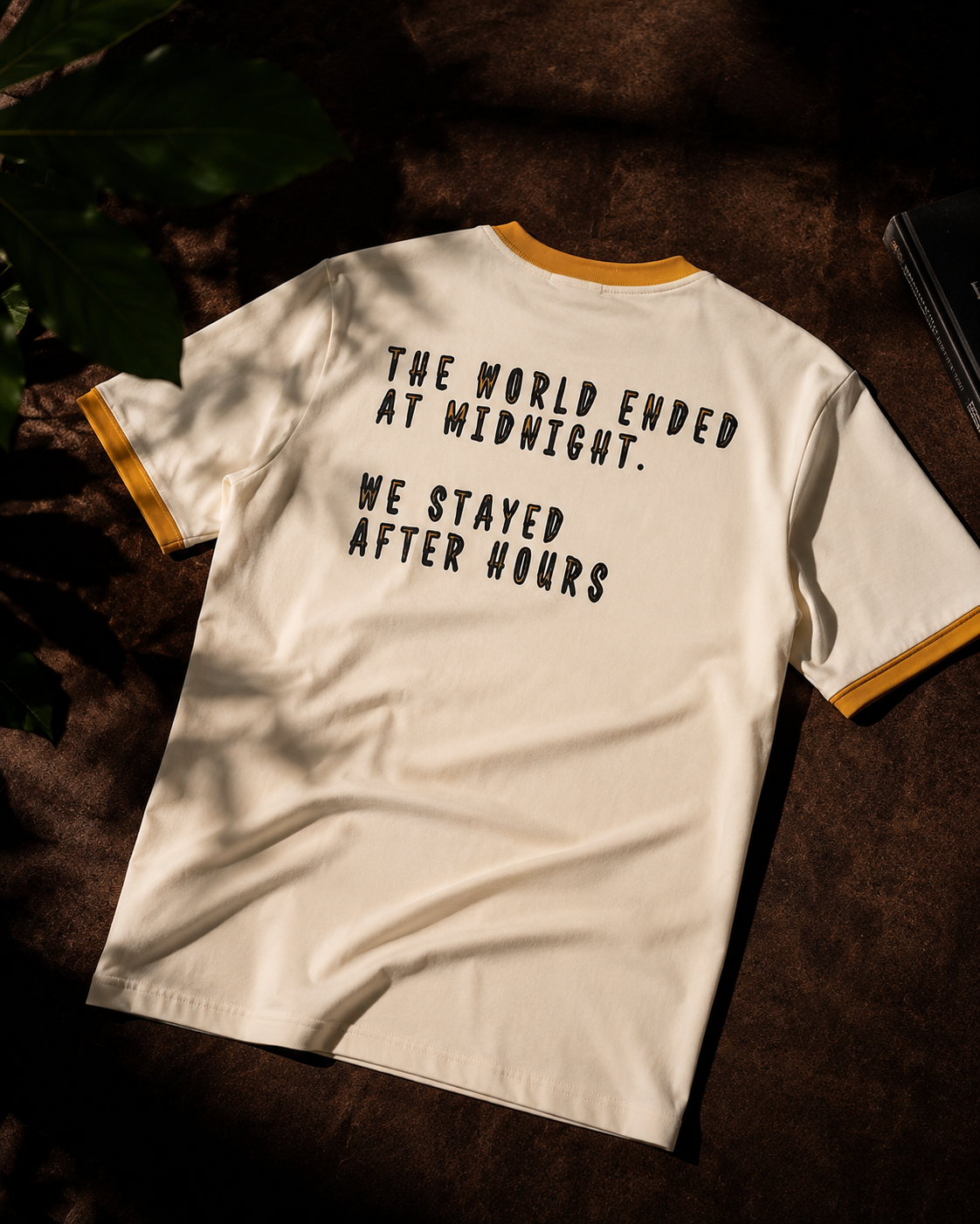 White t-shirt with black text on a dark surface