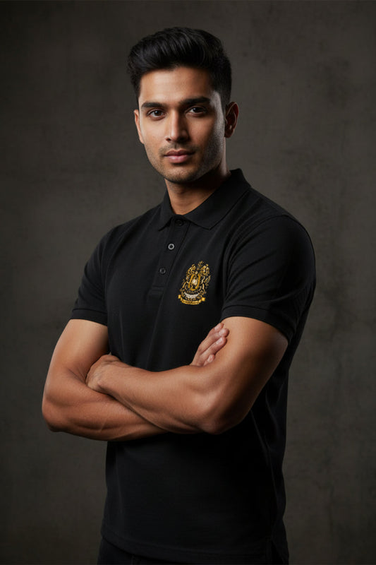 Black polo shirt with the After Hours Coat of Arms emblem on a grey textured wall background