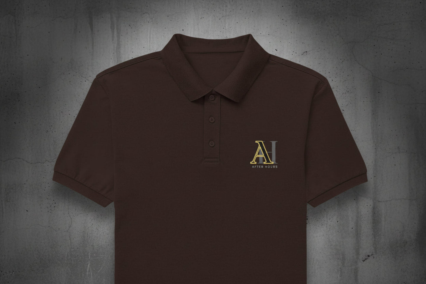 Brown polo shirt with a yellow logo on a grey textured wall background