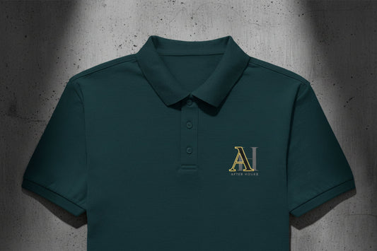 Petrol blue polo shirt with yellow logo on a grey textured wall background