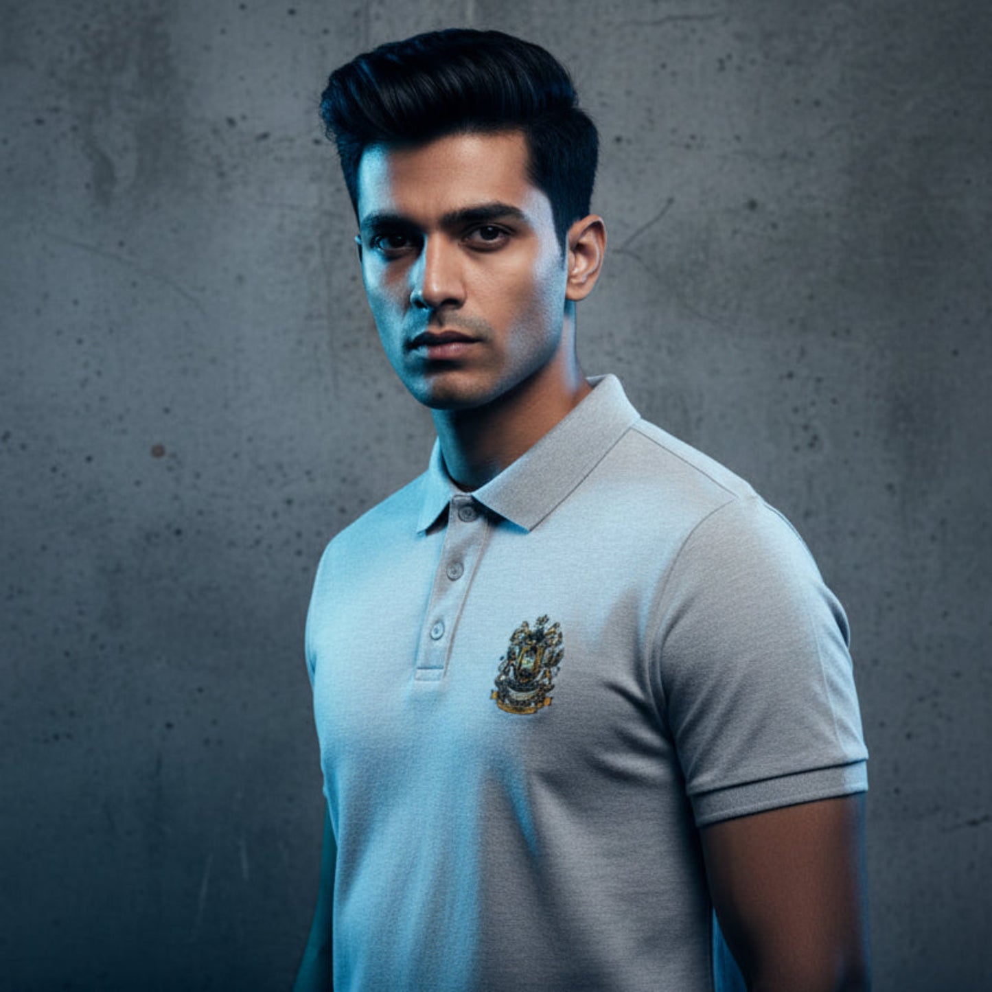 Grey polo shirt with the After Hours Coat of Arms emblem on a grey background