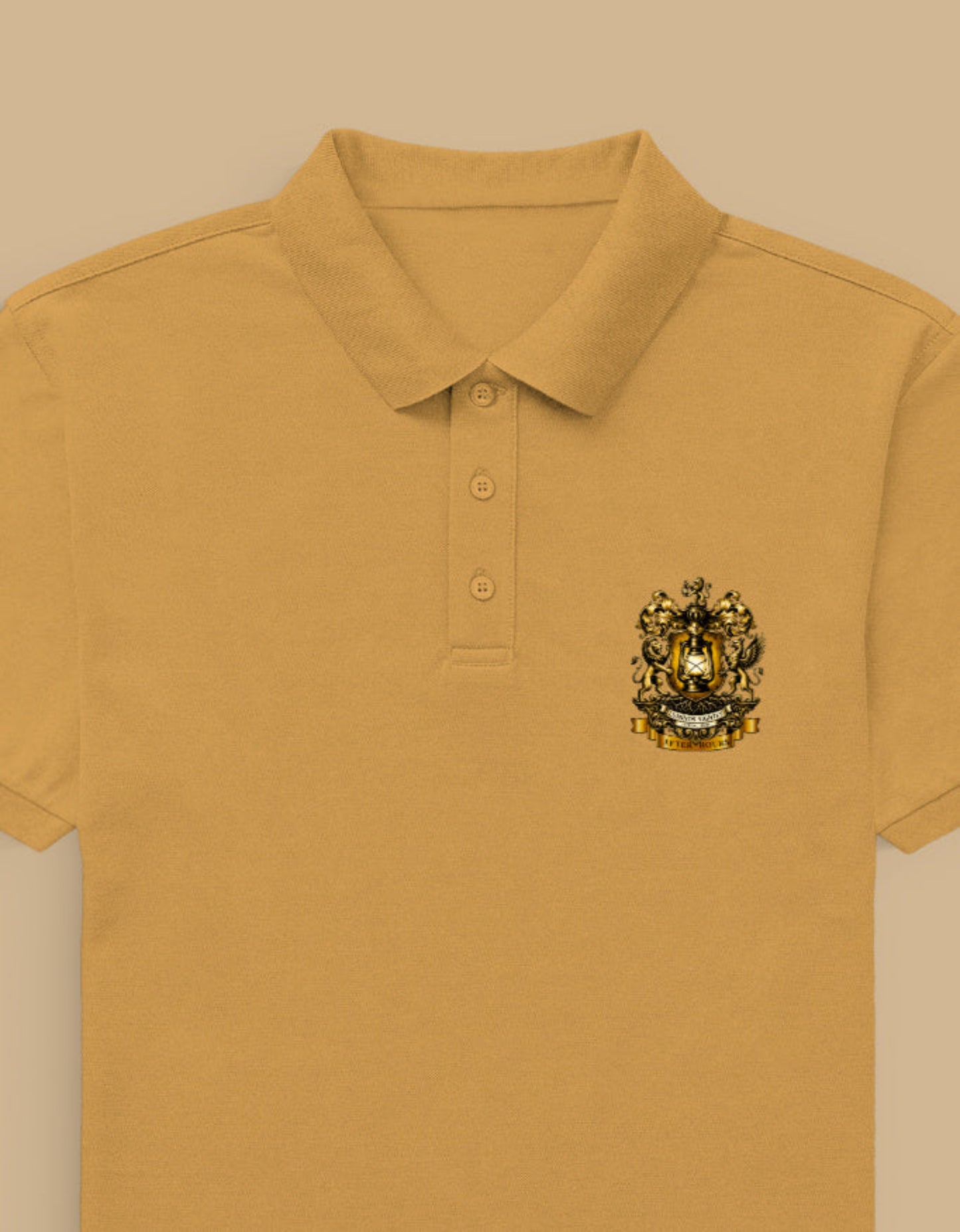 Golden yellow polo shirt with the After Hours Coat of Arms emblem on a beige background