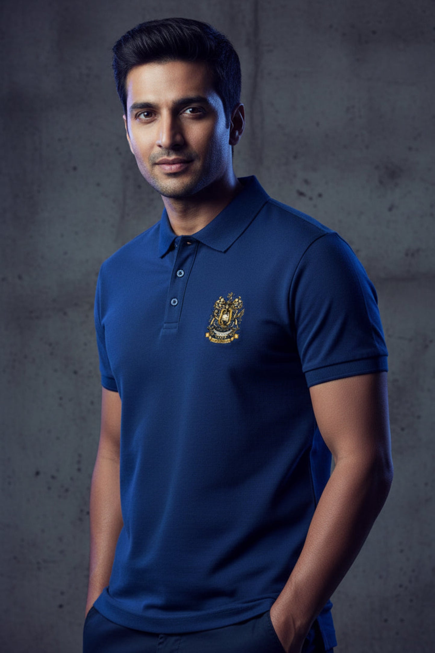 Royal blue polo shirt with the After Hours Coat of Arms emblem on a grey background