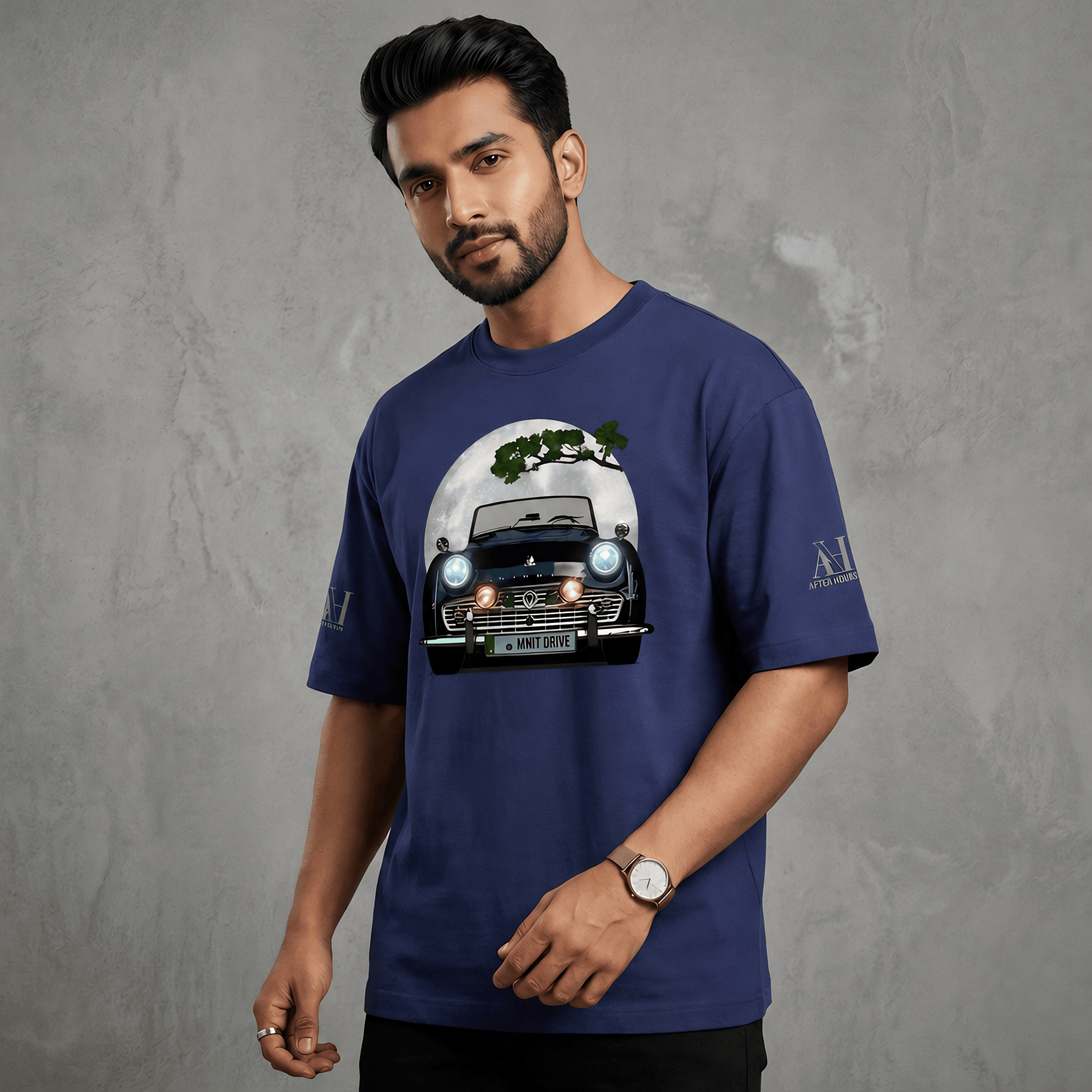 Man wearing a blue t-shirt with a graphic design on a gray background