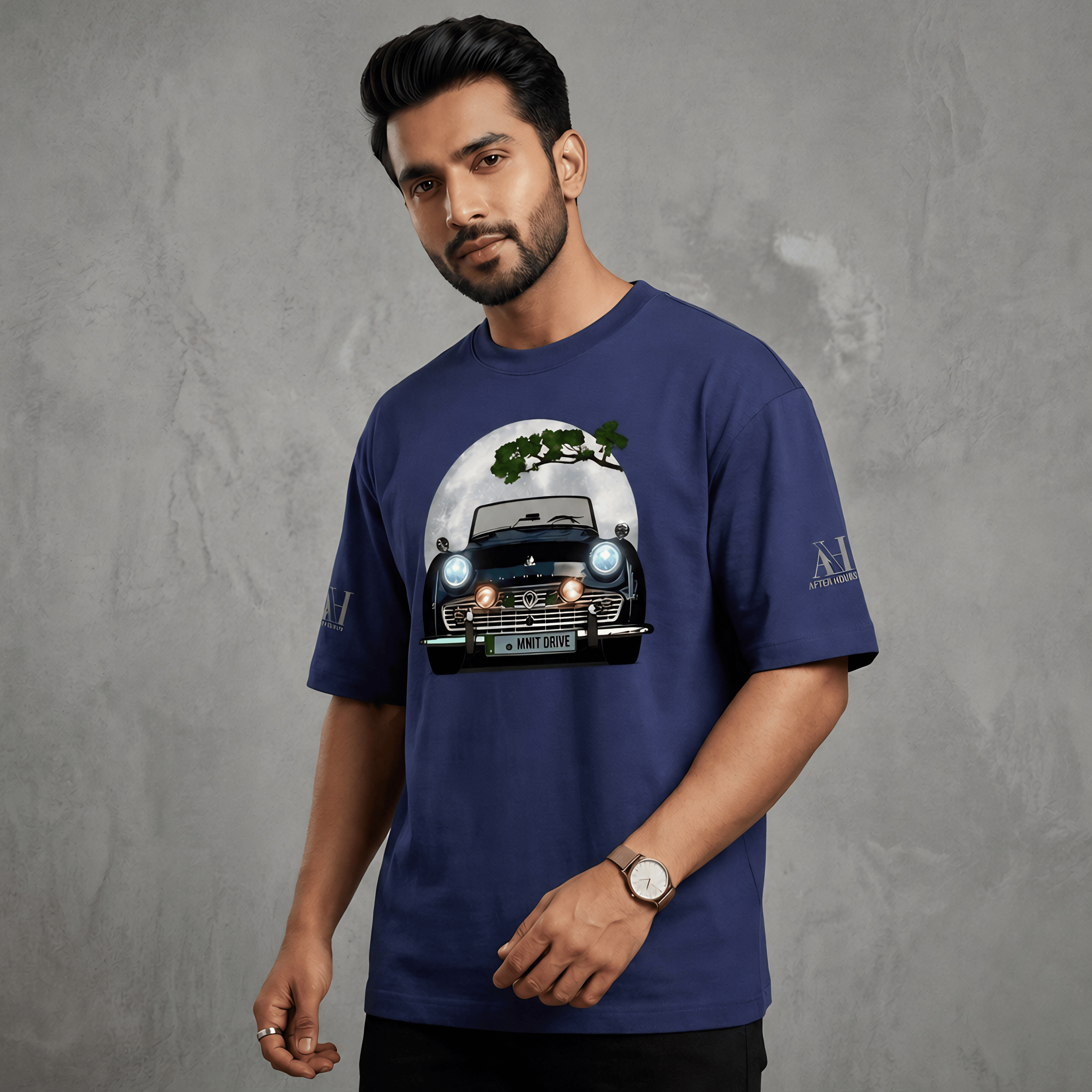 Man wearing a blue t-shirt with a graphic design on a gray background