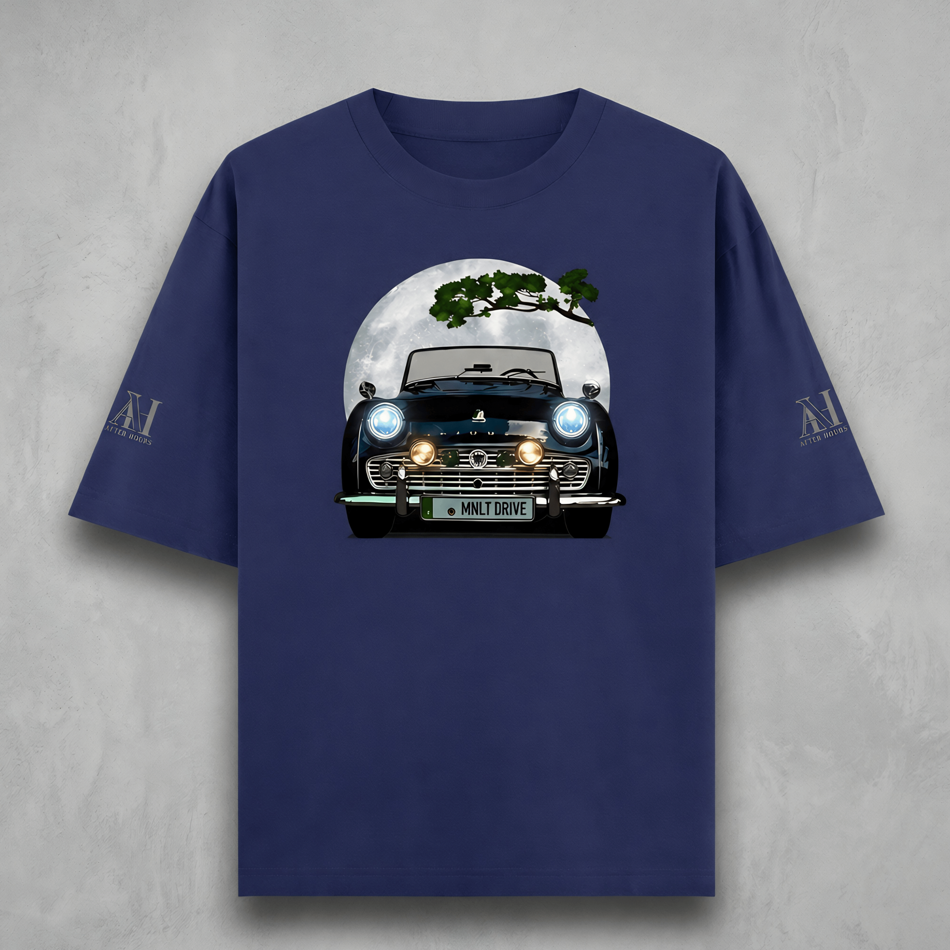 Navy blue t-shirt with a graphic of a car and tree on a gray background
