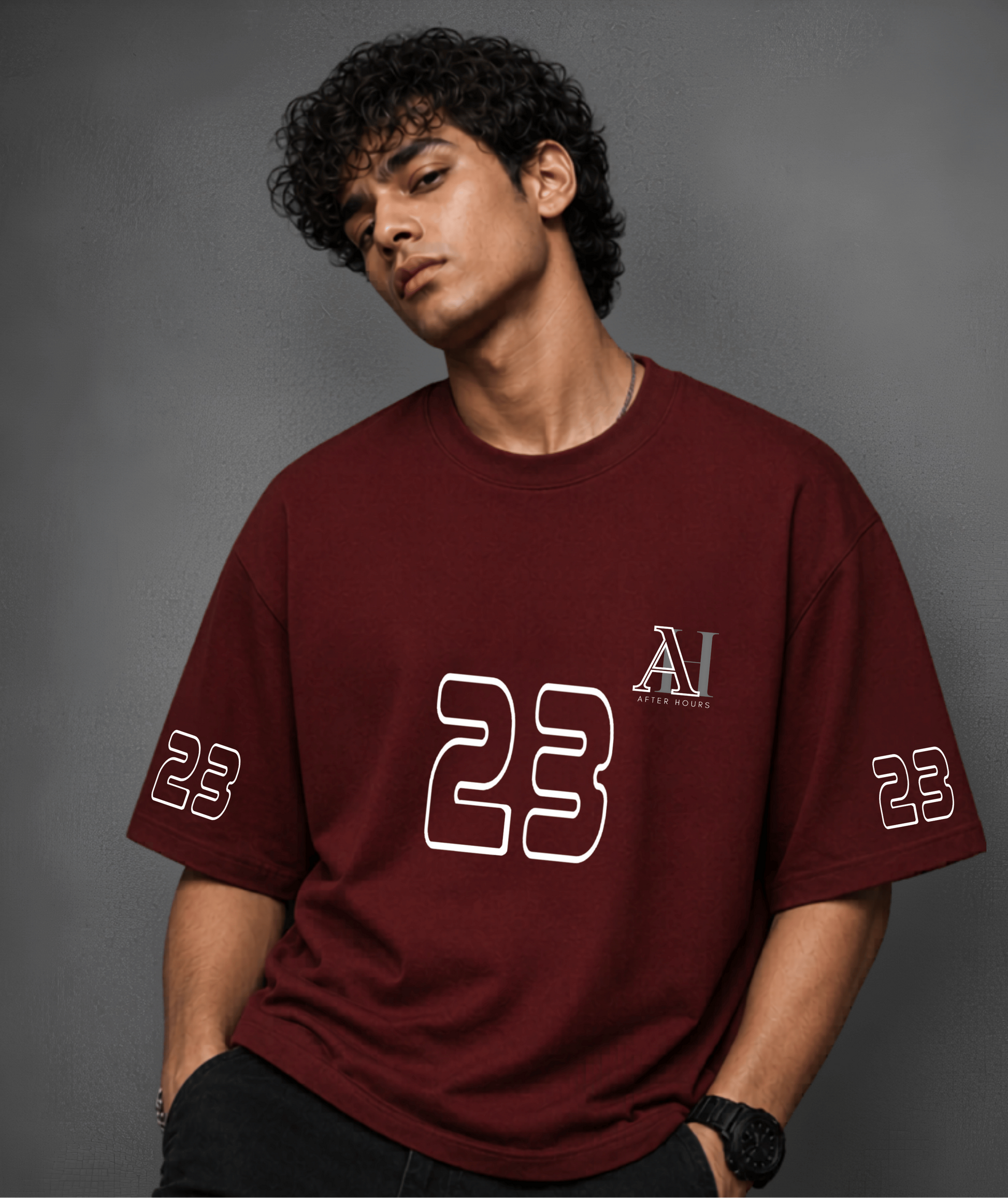 Person wearing a red t-shirt with '23' and logo on a grey background