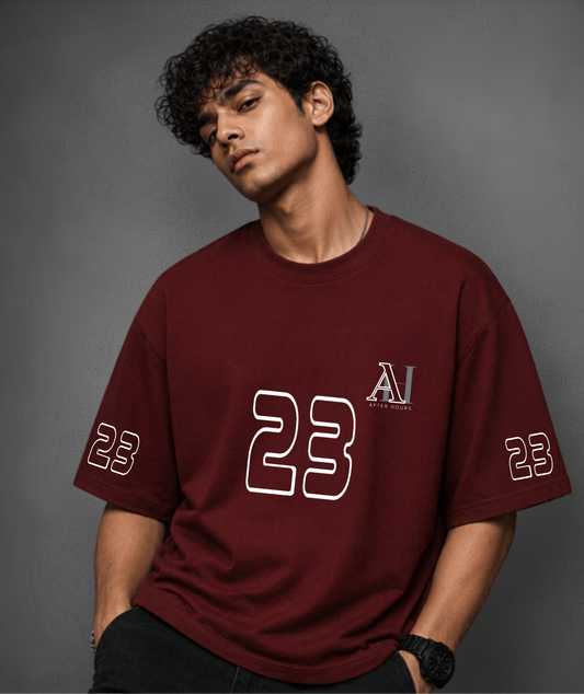 Person wearing a red t-shirt with '23' and logo on a grey background