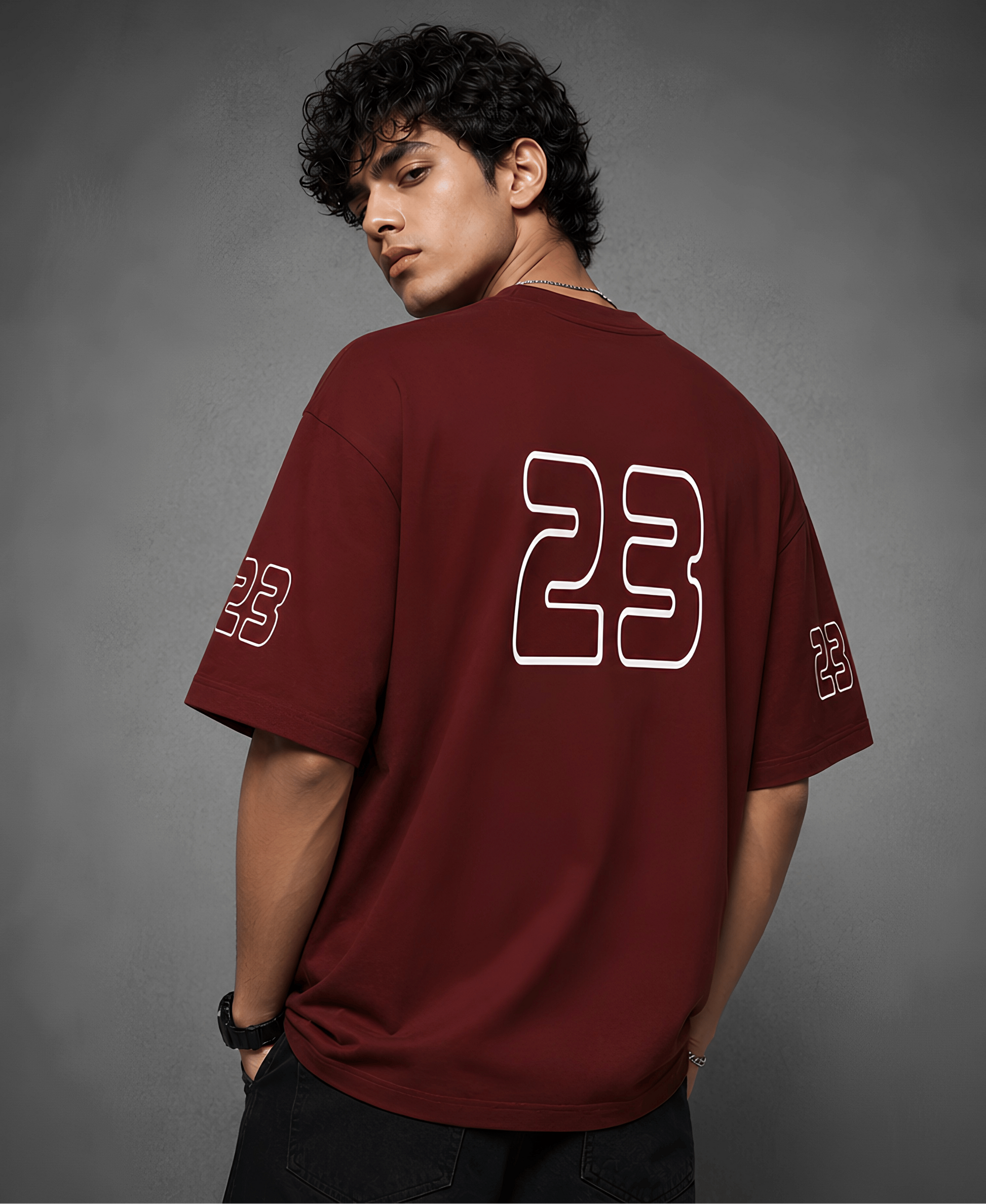 Person wearing a red t-shirt with number 23 on the back against a grey background