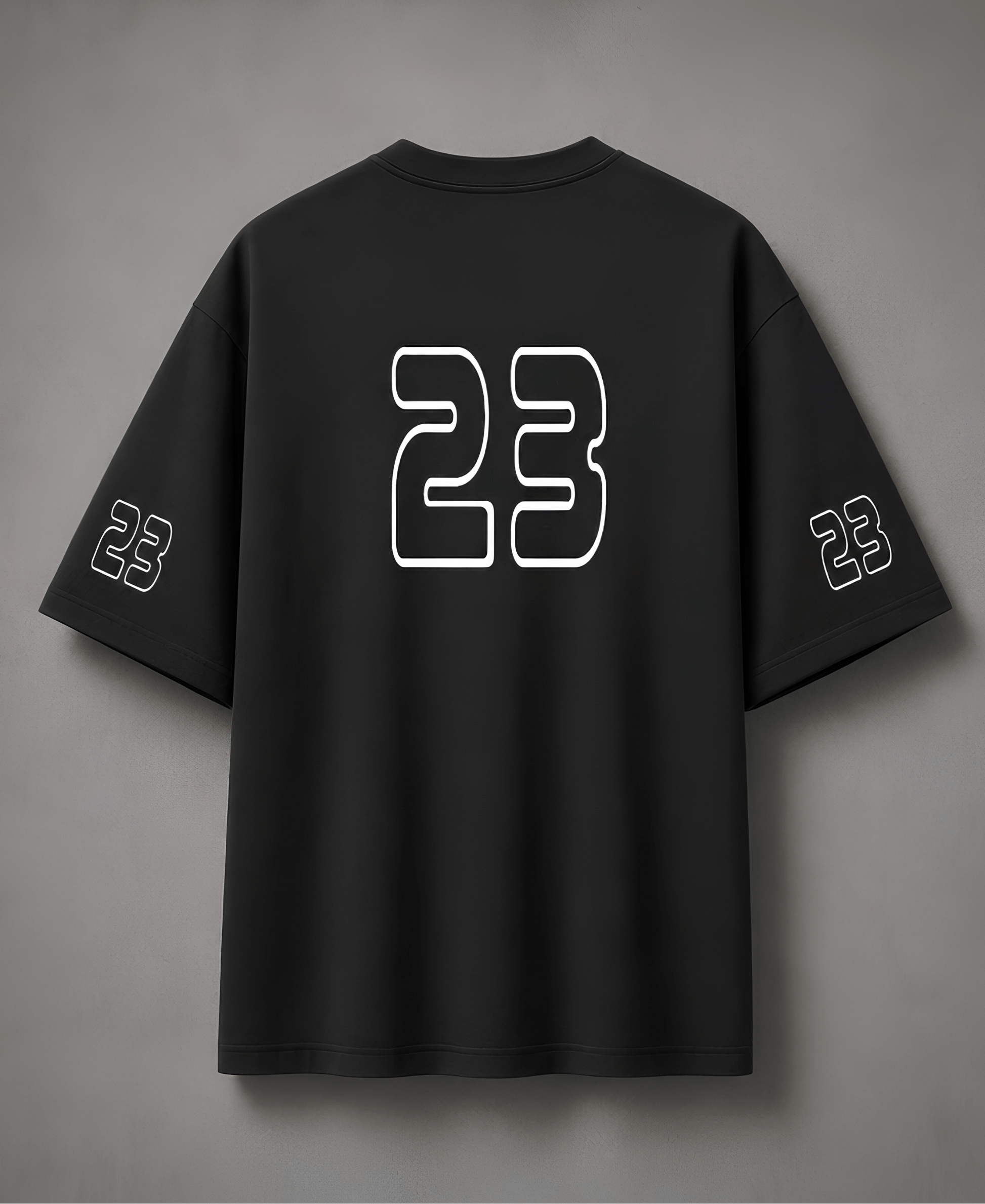 Black t-shirt with number 23 on the back against a grey background