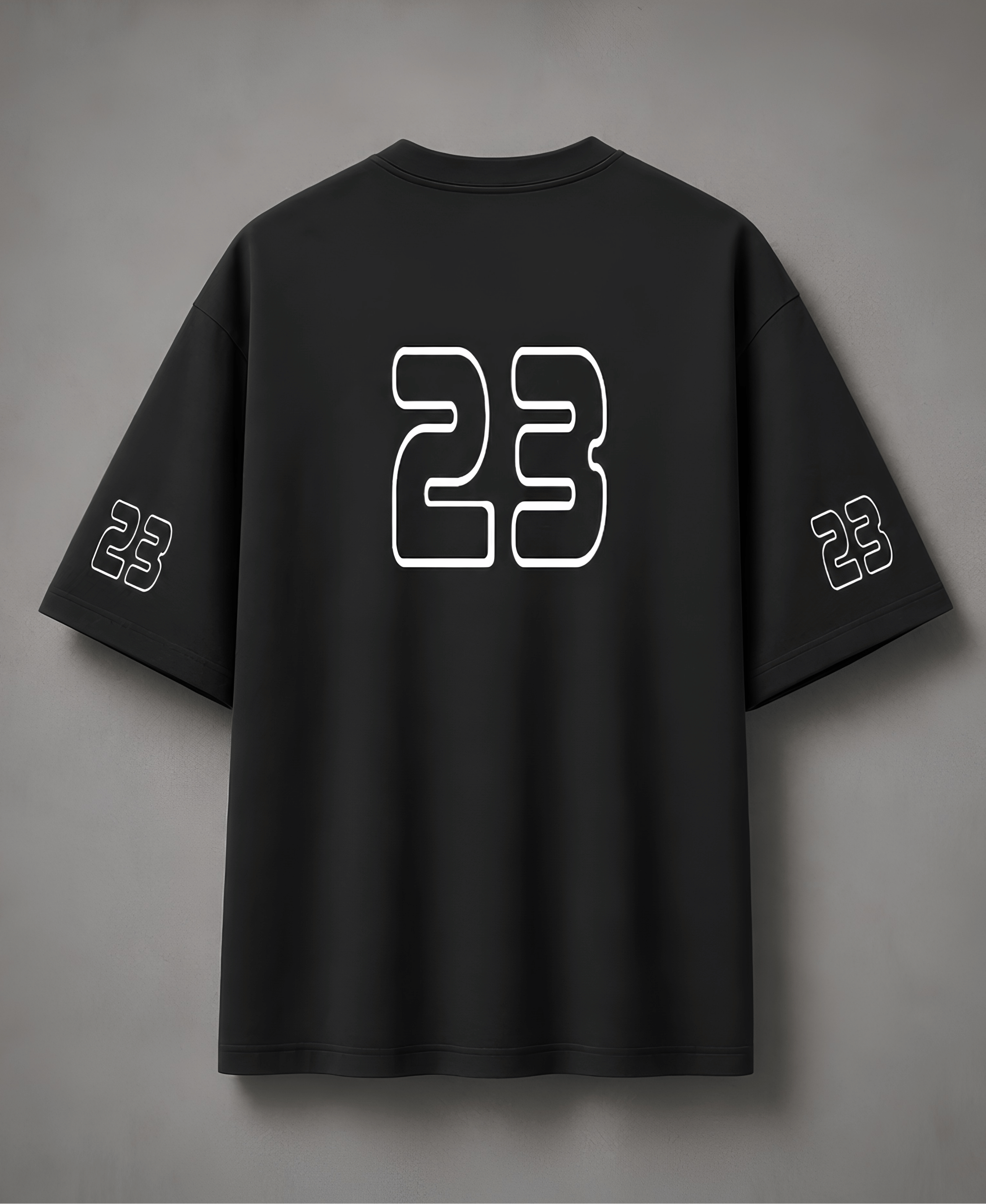 Black t-shirt with number 23 on the back against a grey background