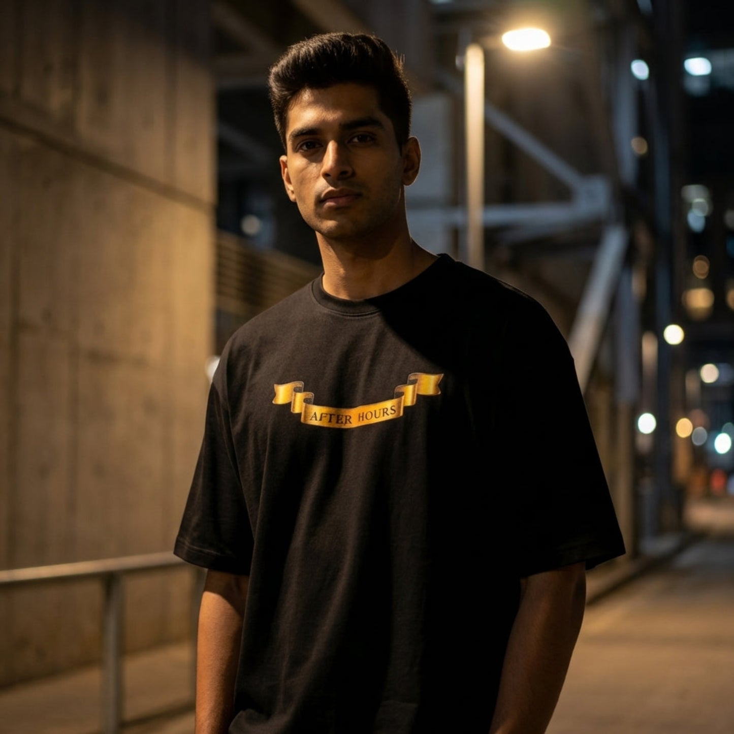 Hyper-realistic close-up of the After Hours Nocturnal Crest oversized tee's chest graphic, showing sharp lines and textured heavyweight cotton.