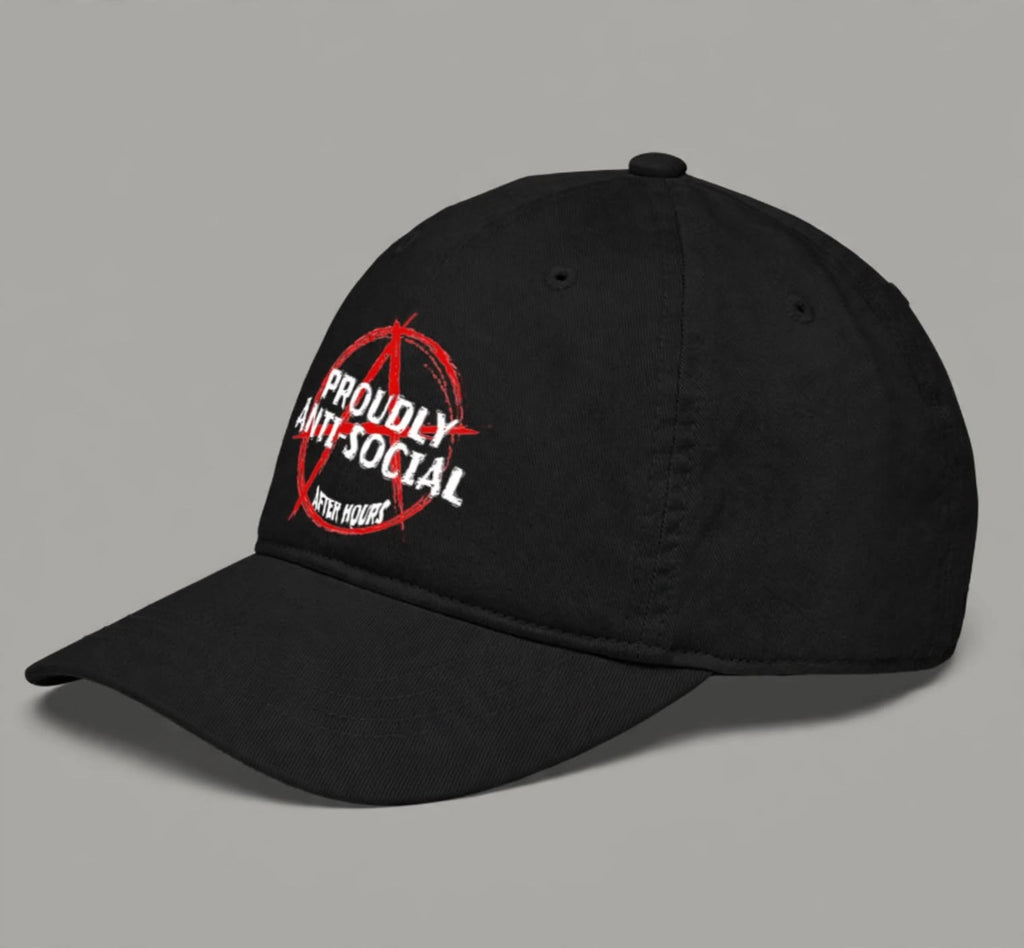 A black baseball cap with a curved brim, featuring a red and white graphic print on the front that reads 'PROUDLY ANTI-SOCIAL' with a red anarchy symbol and 'AFTER HOURS' below, shown on a plain gray background.