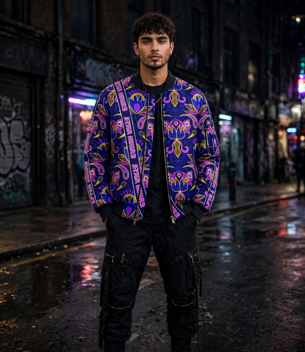 A man stands on a wet city street at night wearing a vibrant purple bomber jacket with a colorful floral pattern and black cargo pants.