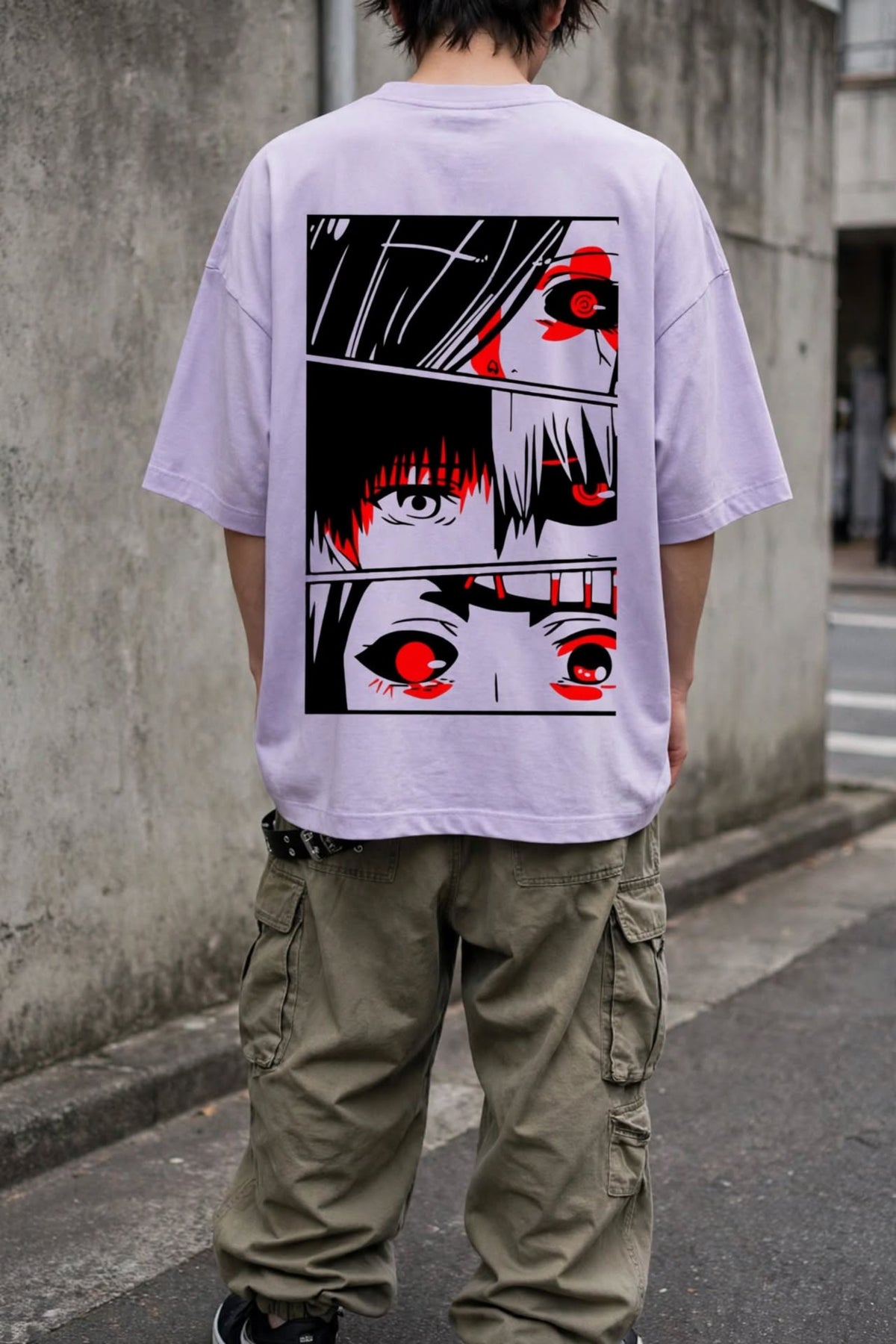 A person viewed from behind wearing an oversized light lavender t-shirt with a large graphic print of anime-style eyes in black, white, and red on the back, paired with olive cargo pants.