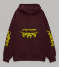 A dark maroon pullover hoodie with a yellow graphic print on the chest reading 'AFTER HOURS' and matching yellow tribal-style sleeve prints, shown against a neutral grey background.