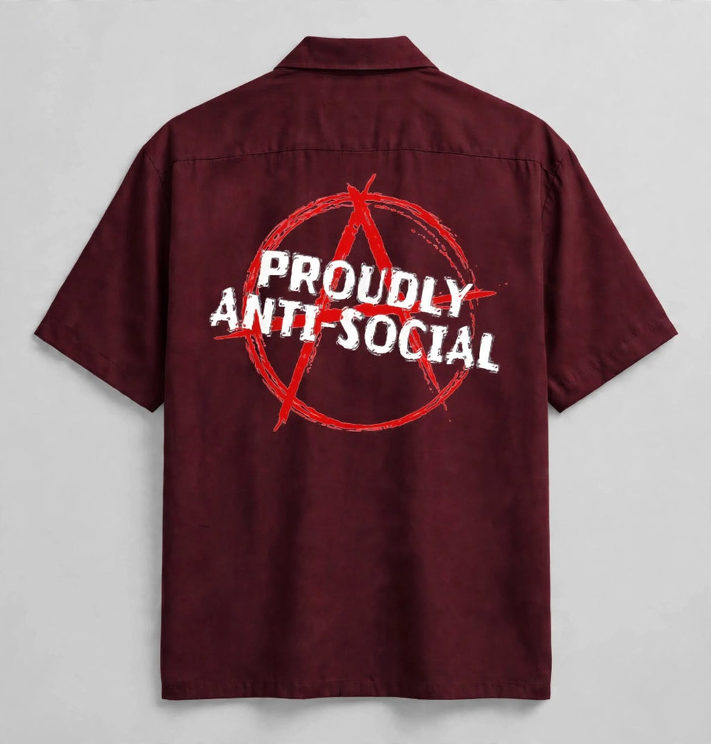 A short-sleeve button-up shirt shown from the back, featuring a large red anarchist symbol and the words 'PROUDLY ANTI-SOCIAL' printed in white across the center.