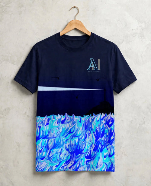 A navy blue t-shirt hanging on a wooden hanger against a textured light grey wall. The shirt features a graphic design with a dark navy sky, white horizon line, and a detailed blue and white wave pattern at the bottom.
