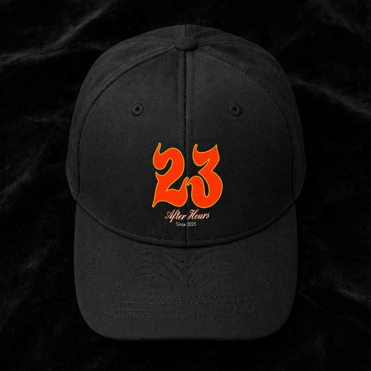 A black baseball cap featuring a prominent orange '23' graphic on the front, with 'After Hours' and 'Since 2025' written in white script underneath, set against a black textured background.