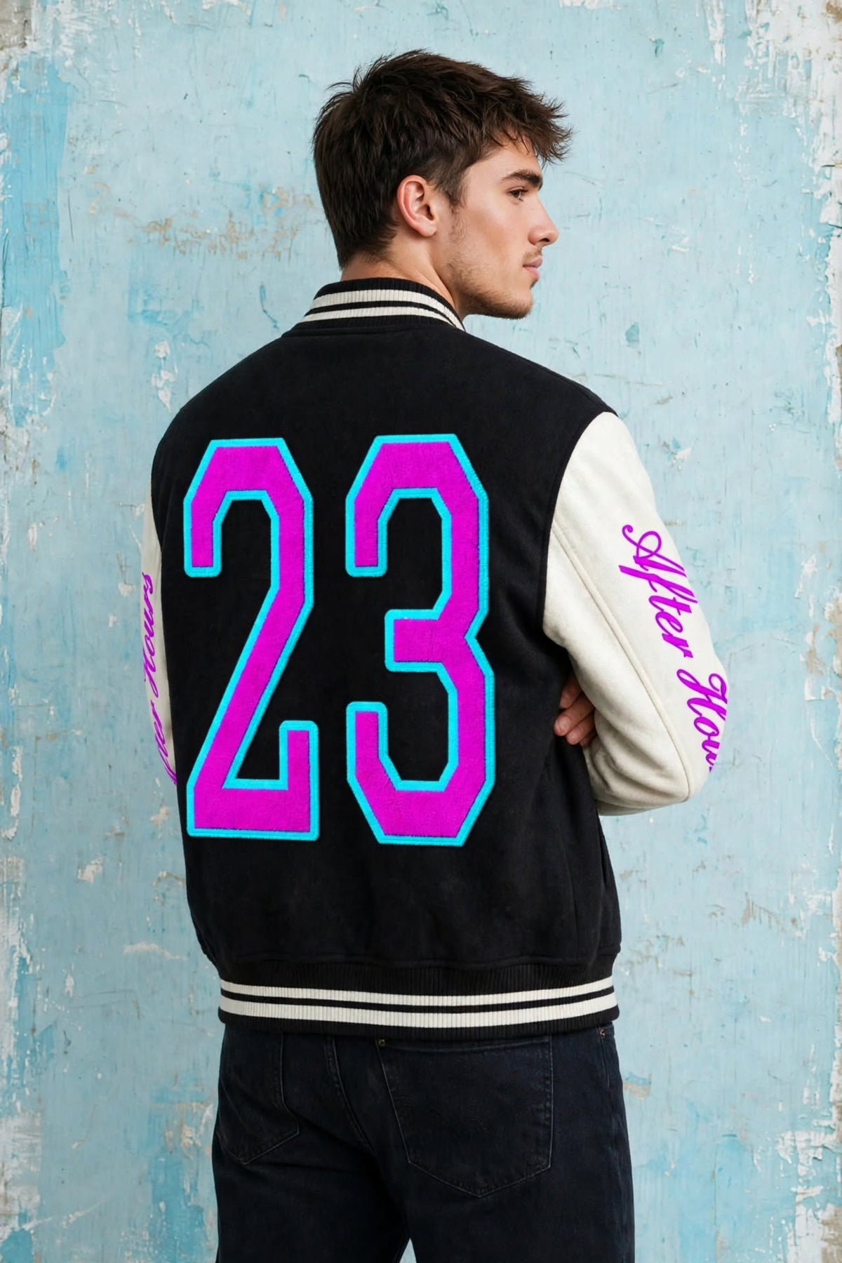 A man wearing a black and white varsity jacket, shown from the back. The jacket features a large neon pink and cyan number '23' on the back, with 'After Hours' written in pink script on the left sleeve.